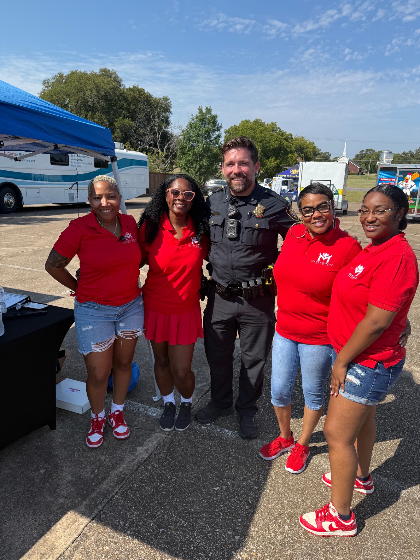 Mastermind team with a Fort Worth police officer at a community event